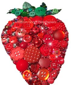 an apple made up of many different types of buttons and sequins on a white background