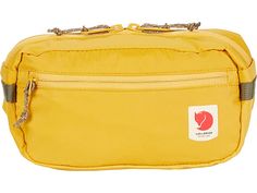 a yellow fanny bag with a chain hanging from it's front pocket and two zippers on the side