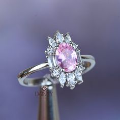 Tourmaline Oval Cut Engagement Ring I 14K White Gold Halo Ring I Unique Pink Tourmaline Ring I October Birthstone Ring I Christmas Gift  Item Gemstone: Tourmaline  Size: 7*5    3*2   3*1.5 Color: Pink Shape: Oval Cut And Marquise Cut Average Quality: AAA+ This exquisite ring features a captivating pink tourmaline stone at its center, masterfully cut into an elegant oval shape. The stone, measuring 7mm by 5mm, exudes a vibrant and rich pink hue, captivating the eye with its enchanting brilliance and depth.  Surrounding the central pink tourmaline is a halo of sparkling diamonds, meticulously set to enhance the stone's natural beauty and add an extra touch of glamour. Each diamond is carefully chosen for its clarity and radiance, creating a dazzling frame that complements the central stone p Pink Oval Halo Ring As A Gift, Pink Oval Birthstone Ring, Pink Ruby Halo Ring Perfect For Gift, Pink Ruby Ring With Halo For Gift, Gift Pink Ruby Halo Ring, Gift Pink Halo Ruby Ring, Pink Oval Halo Ring For Gift, Pink Oval Sapphire Ring As Gift, Pink Tourmaline Rings