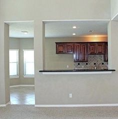 an empty kitchen and living room with tile flooring in a house or apartment area