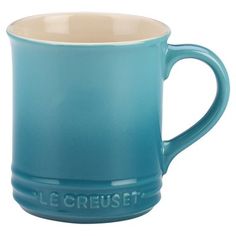 a blue mug with the word le creuset on it