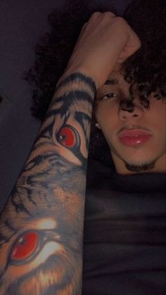 a man with a tiger tattoo on his arm