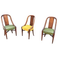 three wooden chairs with green and yellow upholstered seat cushions on each one side