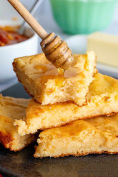 honey is being drizzled on top of cornbreads