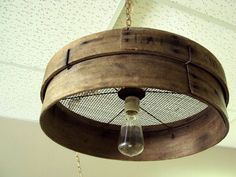 a wooden light fixture hanging from the ceiling