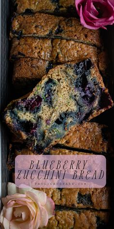 close up image of blueberry zucchini loaf with an abundance of fresh blueberries in bread and zucchini with pink flowers Quick Breads, Lots Of Love