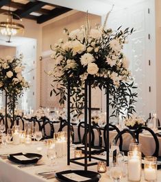 the centerpieces are decorated with white flowers and candles