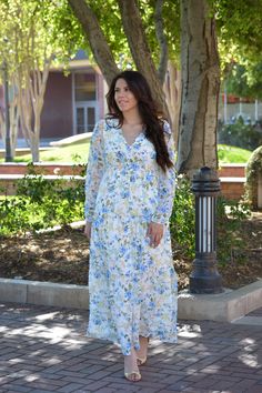 We just love this new brand. And this dress is beautiful! So perfect for spring and summer. Selena features a buttoned front (great for nursing moms), lining to hem, elastic back waist and long sleeve in a tiered design. Florals consist of shades of blue, yellows, and peach. Fabric does not have stretch. Modeled in small 5’6. 100% Polyester - out /100% Rayon - lining XSmall (bust 36”/waist 30-32”/length Small (bust 38”/waist 32-34”/length 56”) Medium (bust 40”/waist 34-36”/length 56”) Large (bus Spring Floral Print Maxi Dress With Empire Waist, Modest Maternity Maxi Dress For Spring, Spring Dresses With Smocked Back And Empire Waist, Spring Maternity Dresses With Flowy Fit, Spring Maternity Flowy Dress, Modest Flowy Maxi Dress For Spring, White Spring Maternity Maxi Dress, Spring Maxi Dress With Smocked Back And Empire Waist, Modest Spring Dress With Smocked Back