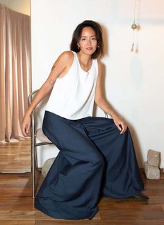 This sleek and minimal high-waisted wide leg pants is a full-length design featuring no pockets or side seams creating a streamlined silhouette. the front zipper with clasp enclosure and deep front pleat gives the appearance of a skirt while actually being a pant. these pants offer a slim high-waisted fit similar to our sam high-waisted pant.    waist measurement: xxs (64cm) xs (67cm) s (70cm) m (75cm) l (80cm) Modern Wide Leg Blue Pants, Modern Blue Wide Leg Pants, Modern Wide-leg Pants For Summer, Modern Blue Wide-leg Pants, Modern High-waisted Wide Leg Summer Pants, Modern Wide Leg Trousers For Summer, Chic Blue Wide Leg Culottes, Modern Wide Leg Pants With Loosely Fitted Hips, High Waisted Wide Leg Pants