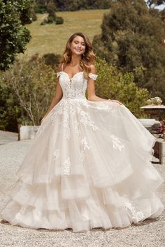 a woman in a wedding dress posing for the camera