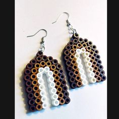 the earrings are made out of legos and have white letters on each earring