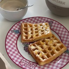 two waffles on a pink and white plate