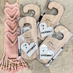 four wooden door hangers with i'm a princess written on them next to a pink tassel