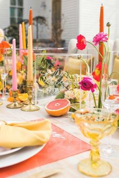 the table is set with candles and plates