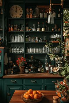 a kitchen filled with lots of green cupboards and counter top covered in pots and pans