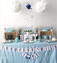 a baby shower party with blue and white decorations