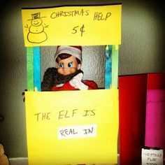 an elf with a beard and hat in a cardboard box that says the elf is real tv