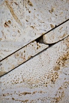 a close up view of the surface of a wall with cracks and dirt on it