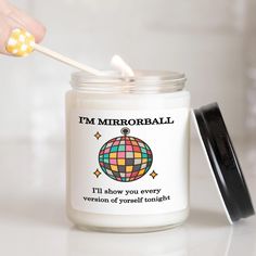 a person is holding a toothbrush in a jar that says i'm mirrorball