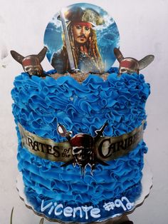 a birthday cake decorated with blue icing and pirate's chest on the top