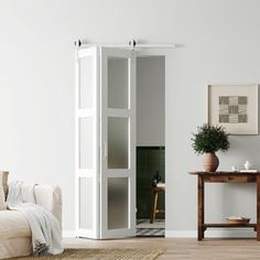 a living room with white walls and furniture