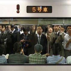 a group of people standing next to each other on a train