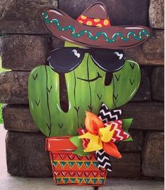 a cactus with sunglasses and a hat on it