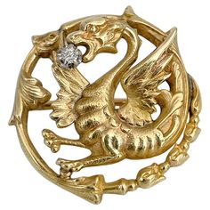 This is a Victorian chimera or dragon pin brooch. It is crafted in 18K gold. Circa 1890. The piece features an old cut diamond. Weight: 7.75g Size: 2.7x2.7cm IMPORTANT: As a buyer, you are fully responsible for the customs duties, other local taxes and any administrative procedures related to imports into the country of destination. ——— If you have any questions, please feel free to ask. We describe our items accurately. Please note that in reality they can look much better because photo can’t capture that magical sparkle. We have many years of experience in this business. And we have a very carefully curated selection of pieces. You can buy with confidence. Thank you for your consideration. ——— "Laura Antiques Fine Jewellery” is a successful family-owned business since 2009. Our enthusias Luxury Gold Brooches With Diamond Accents, Luxury Ornate White Gold Brooches, Luxury Traditional Brooches With Filigree, Successful Family, Diamond Brooch, Christian Lacroix, Rose Cut Diamond, Antique Jewellery, Fine Jewellery