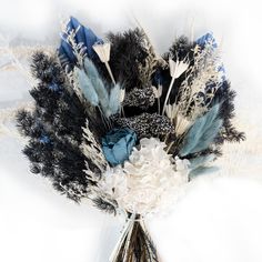 an arrangement of feathers and flowers in a vase