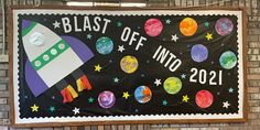 a bulletin board with the words blast off into 2012 written on it and an outer space theme