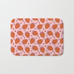 an orange and pink strawberry pattern bath mat