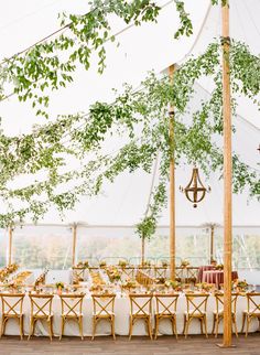 an outdoor tent set up with tables and chairs