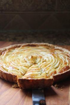 a pie sitting on top of a wooden cutting board