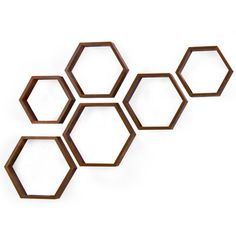 four wooden hexagons on a white wall with one facing the camera and three behind them