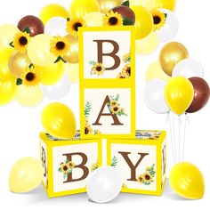 sunflowers and balloons are arranged around the blocks that spell it's baby