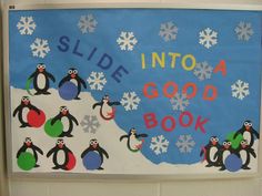 a bulletin board with penguins and snowflakes on it that says slide into a good book