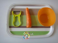 a plastic tray with carrots and scissors on it