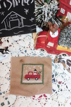 a table topped with different types of christmas decorations and ornaments on top of a doily