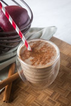 an apple and cinnamon smoothie with two straws