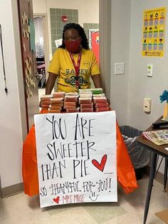 a woman standing behind a sign that says you are sweeter than pie