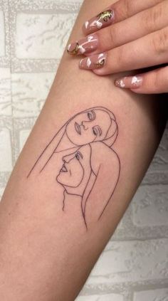 a woman's arm with a drawing of a man and woman on the side