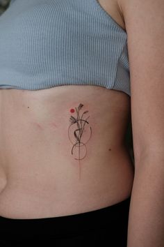 a woman with a flower tattoo on her stomach