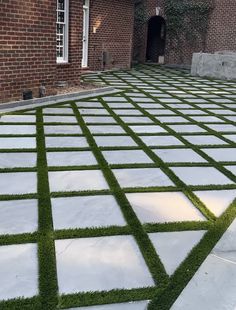 an outdoor area with grass and brick walls