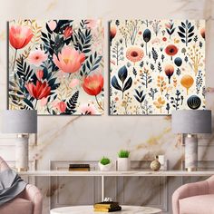 two floral paintings on the wall in a living room with pink chairs and a coffee table