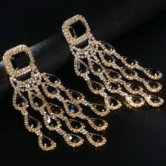 Add a touch of glamour to your look with our Elegant Bridal Crystal Tassel Earrings. Featuring a large pendant with shimmering black crystals and a graceful water drop design, these exaggerated dangle earrings are perfect for parties and special occasions. Ideal for brides and party-goers alike, these stunning earrings will ensure you stand out in any crowd. Material: Rhinestone Metals Type: Copper Item: Crystal Tassel Earrings Style: TRENDY *Note Delivery Time: Due to the current global crisis