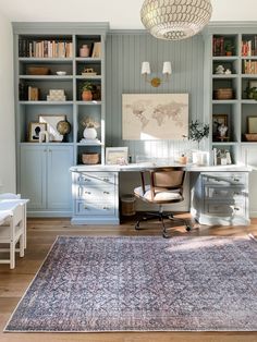 a home office with built in bookcases and a rug