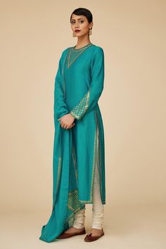 Teal blue full sleeves straight kurta in chanderi base with sequin tikki jaal embroidery on the neckline, sleeves hem and borders. Paired with ivory cotton churidar and embroidered viscose organza dupatta.
Components: 3
Pattern: Embroidery
Type Of Work: Sequin Tikki Jaal
Neckline: Round
Sleeve Type: Full
Fabric: Kurta: Chanderi, Dupatta: Viscose Organza, Churidar: Cotton
Color: Blue
Other Details: 
Length:
Kurta: 46inches
Churidar: 58inches
Dupatta: 2.5metres
Occasion: Puja - Aza Fashions Festive Long Sleeve Unstitched Suit With Gota Work, Chanderi Palazzo Set With Resham Embroidery And Long Sleeves, Long Sleeve Raw Silk Palazzo Set With Zari Work, Designer Long Sleeve Churidar With Dabka Work, Eid Long Sleeve Slub Silk Palazzo Set, Eid Long Sleeve Palazzo Set With Gota Work, Eid Palazzo Set In Raw Silk, Festive Long Sleeve Designer Palazzo Set, Chanderi Sets With Gota Work And Long Sleeves