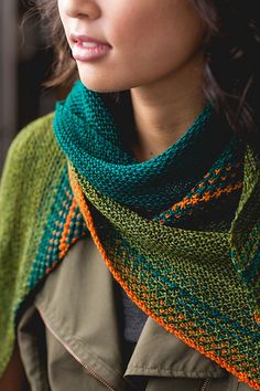 a woman wearing a green and orange scarf