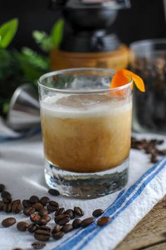 a glass filled with liquid and an orange peel