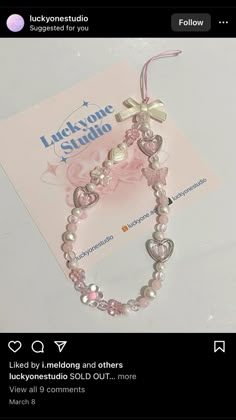 a pink bracelet with hearts and pearls on it